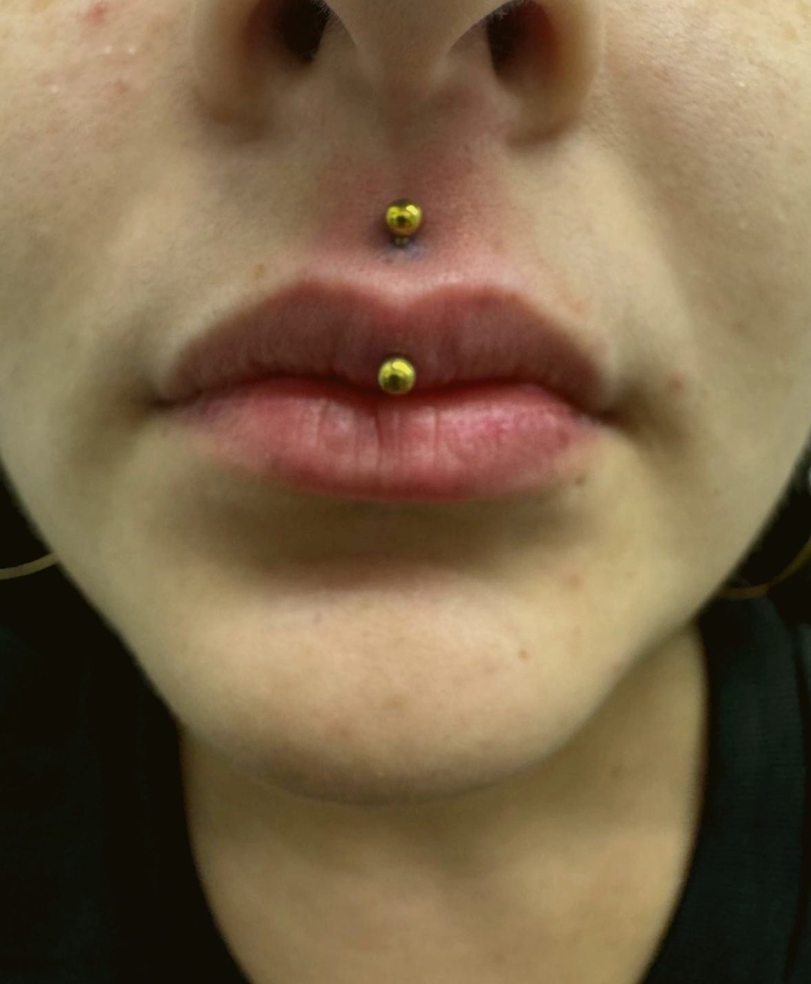 Vertical labret in gold hearts — by Ana, Crown Ink Studio Brooklyn