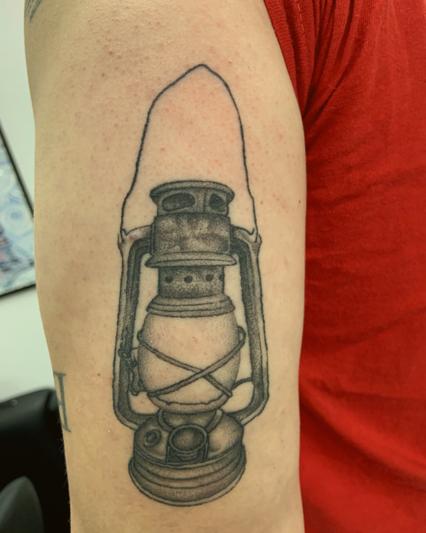 Fine-line lantern on the upper arm — by Edwin Delarosa, Crown Ink Studio Brooklyn
