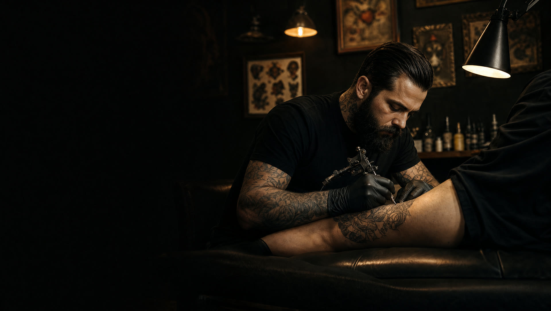 Crown Ink Studio tattoo artist working under warm studio lamps in Crown Heights, Brooklyn